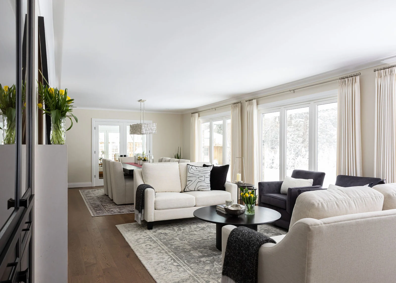 Campbell Avenue living room with warm wood floors and a wall of windows